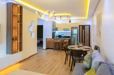 a living room and kitchen with a couch and a table at Step into Elegance - Marrakech in Marrakech