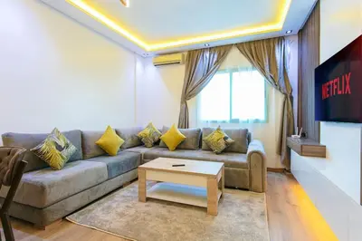 a living room with a couch and a table at Step into Elegance - Marrakech in Marrakech