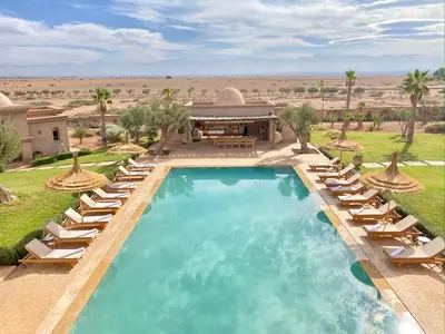 a swimming pool with lounge chairs and a resort at Luxury Villa Rêve D'ahlam à MARRAKECH in Oulad Boudene