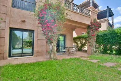 a house with flowers on the side of it at Oasis de l'Atlas by Golf Resort in Marrakech