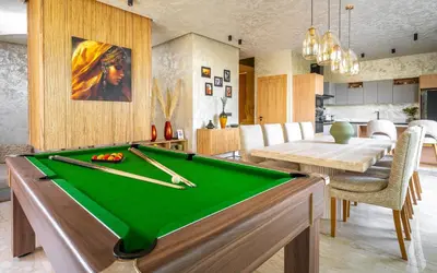 a living room with a pool table and a dining room at Villa ZINA I Luxe I Piscine chauffée I Wifi I Proche centre Ville in Marrakech