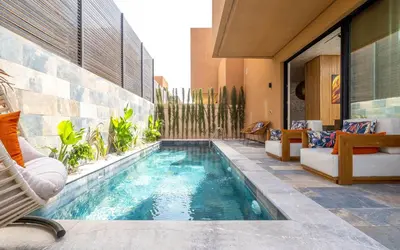 a swimming pool in the middle of a house at Villa ZINA I Luxe I Piscine chauffée I Wifi I Proche centre Ville in Marrakech