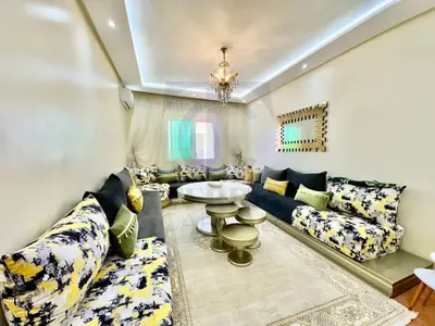 a living room with couches and a table at appartement moderne,gueliz in Marrakech
