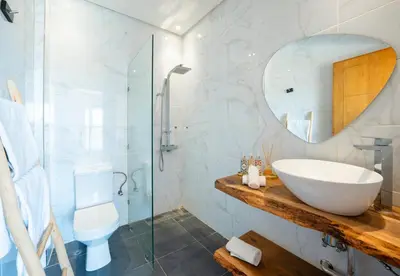 a bathroom with a sink and a glass shower at le petit dar alwalidine in Marrakech