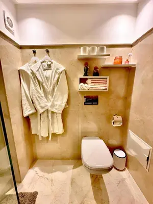 a bathroom with a toilet and a towel rack at Elegant Apartment with Pool, Clim & Wi-Fi - 7min Gueliz in Marrakech