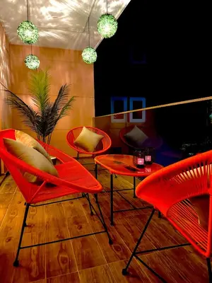 a room with red chairs and a table at Elegant Apartment with Pool, Clim & Wi-Fi - 7min Gueliz in Marrakech