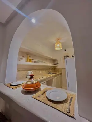 a kitchen with a table with a plate on it at Riad Ouatine in Marrakech