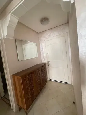 a hallway with a white door and a mirror at Appartement calme près de Gueliz Marrakech in Marrakech
