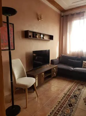 a living room with a couch and a television at Marrakesh 3 Bedroom Oasis in Marrakech