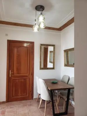 a dining room with a wooden table and chairs at Marrakesh 3 Bedroom Oasis in Marrakech