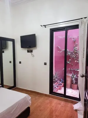 a bedroom with a large window with a view of an aquarium at Step into our little oasis in Marrakech