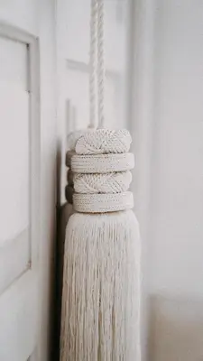 a stack of white yarn hanging from a wall at Riad KRÈME in Marrakech