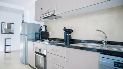a kitchen with a sink and a refrigerator at Havre de Paix à Noria Golf Marrakech in Marrakech