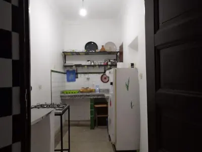 a kitchen with a white refrigerator and a stove at Appart 3 mins from Jamaâ el fana in Marrakech