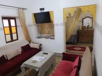 a living room with a couch and a tv at Appart 3 mins from Jamaâ el fana in Marrakech
