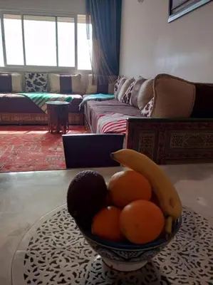 a bowl of fruit on a table in a living room at Le Fairouz Appartement Haut Standing centre ville Piscine in Marrakech