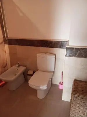 a bathroom with a white toilet and a bidet at Le Fairouz Appartement Haut Standing centre ville Piscine in Marrakech