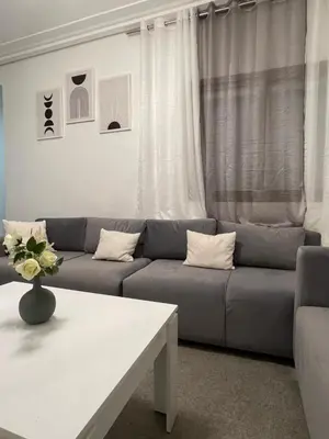 a living room with a couch and a table at Gueliz Marrakech Apartment 5 Min City Center in Marrakech