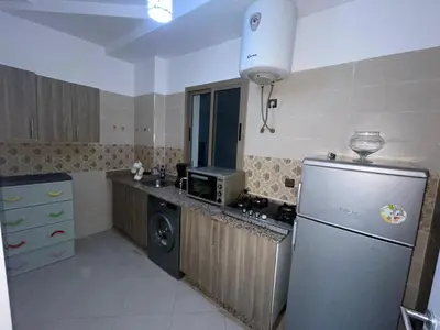 a kitchen with a refrigerator and a microwave at Gueliz Marrakech Apartment 5 Min City Center in Marrakech