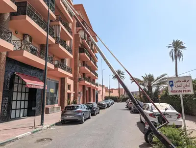 a street with cars parked on the side of a building at Apartement Panoramic View Majorelle Garden with Pool in Marrakech