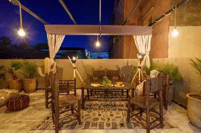 a patio with a table and chairs and a couch at New ! Appartement DarSun - Terrasse - Fibre - Parking by Darlease in Marrakech