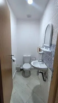 a bathroom with a toilet and a sink at Modern family apartment near airport in Marrakech