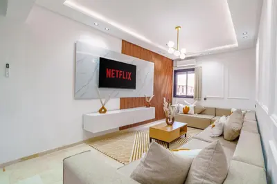 a living room with a couch and a tv at Elegant and cozy 3 bedrooms in Hivernage in Marrakech