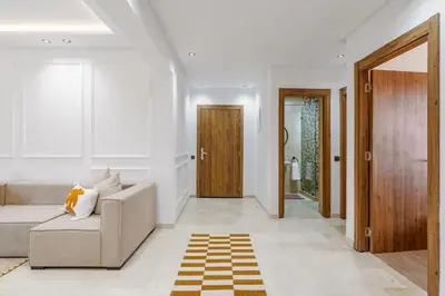 a living room with a couch and a hallway at Elegant and cozy 3 bedrooms in Hivernage in Marrakech