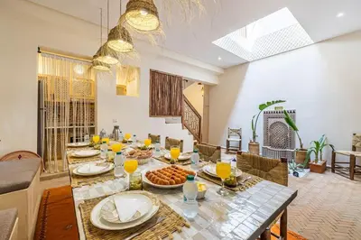 a dining room with a table with food on it at Riad Macan Exclusive and Trendy Chich Breakfast incl in Marrakech
