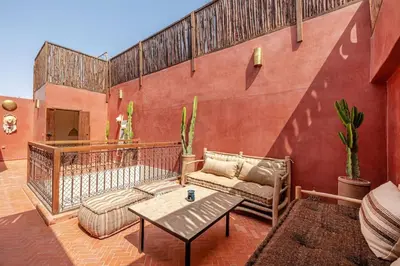 a patio with a couch and a table on a balcony at Riad Macan Exclusive and Trendy Chich Breakfast incl in Marrakech