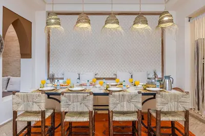 a dining room with a table with chairs and orange juice at Riad Macan Exclusive and Trendy Chich Breakfast incl in Marrakech