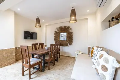 a dining room with a table and chairs and a couch at Riad Zatiah Exclusive and chic breakfast incl in Marrakech