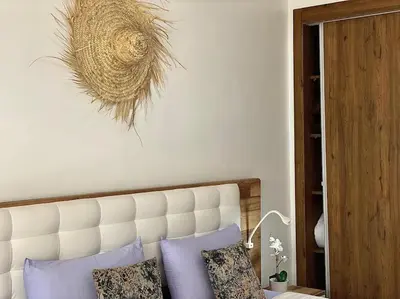 a bedroom with a bed with a white headboard and aisal at Appartement de luxe en face la gare à gueliz marrakech in Marrakech