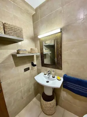 a bathroom with a sink and a mirror at Appartement de luxe en face la gare à gueliz marrakech in Marrakech