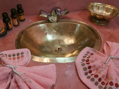 a bathroom sink with pink towels and a faucet at Riad El Bellar in Marrakech