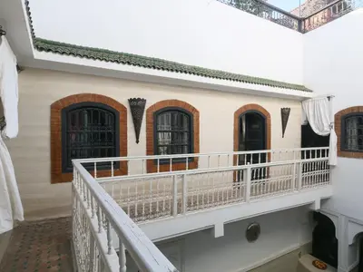 a balcony of a house with black doors and windows at Riad El Bellar in Marrakech