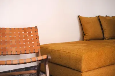 a couch and a chair in a room at Riad JW Yacout, vivez l'expérience Medina in Marrakech