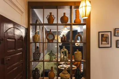 a display case filled with lots of vases at Riad JW Yacout, vivez l'expérience Medina in Marrakech