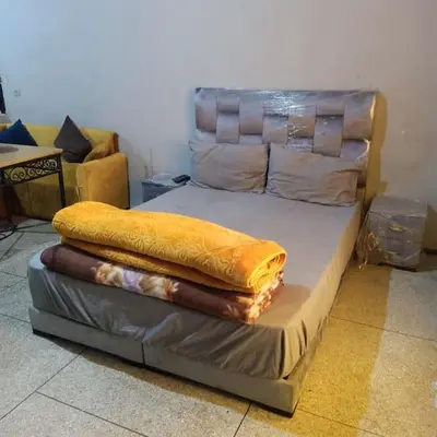 a bed with two blankets on top of it at Cosy & Calm studio in Marrakech