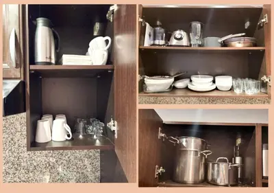 a kitchen cabinet filled with dishes and utensils at Rêve de MARRAKECH in Marrakech