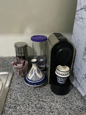 a coffee maker sitting on a counter next to vases at Cosy & Calm appartement in Marrakech