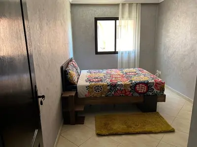 a bedroom with a bed with a quilt on it at Cosy & Calm appartement in Marrakech