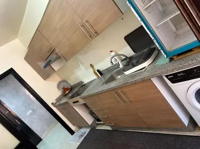 a kitchen with a sink and a washing machine at Cosy & Calm appartement in Marrakech