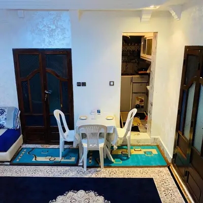 a room with a table and chairs and a door at Dar Al-Karma in Marrakech