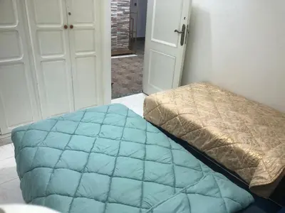 a bedroom with a bed with a blue quilt at Luxury Apartment in Marrakesh two in Marrakech