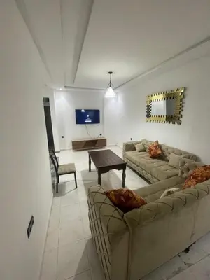 a living room with two couches and a table at Luxury Apartment in Marrakesh two in Marrakech