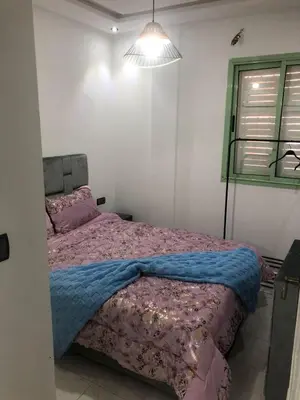a bedroom with a bed with a purple blanket at Luxury Apartment in Marrakesh two in Marrakech