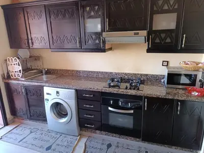 a kitchen with a washing machine and a sink at M32 Cosy Loft in Marrakech