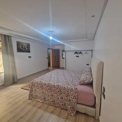 a bedroom with a bed and a couch in it at New DUPLEX jardins d'anas- Avenue guemassa Near Airport in Marrakech