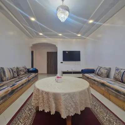 a living room with couches and a table with a tv at New DUPLEX jardins d'anas- Avenue guemassa Near Airport in Marrakech
